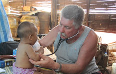 Dr. Myron Semkuley tends a patient at the SAW orphanage Dr. Myron Semkuley tends a patient at the SAW orphanage